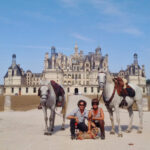 horses and riding in front of french castle horse riding holiday by globetrotting