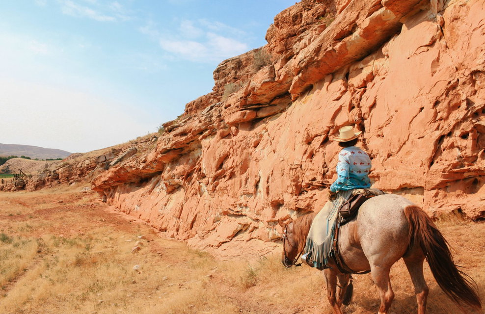 rider in canyon on horse riding holiday Wyoming by globetrotting